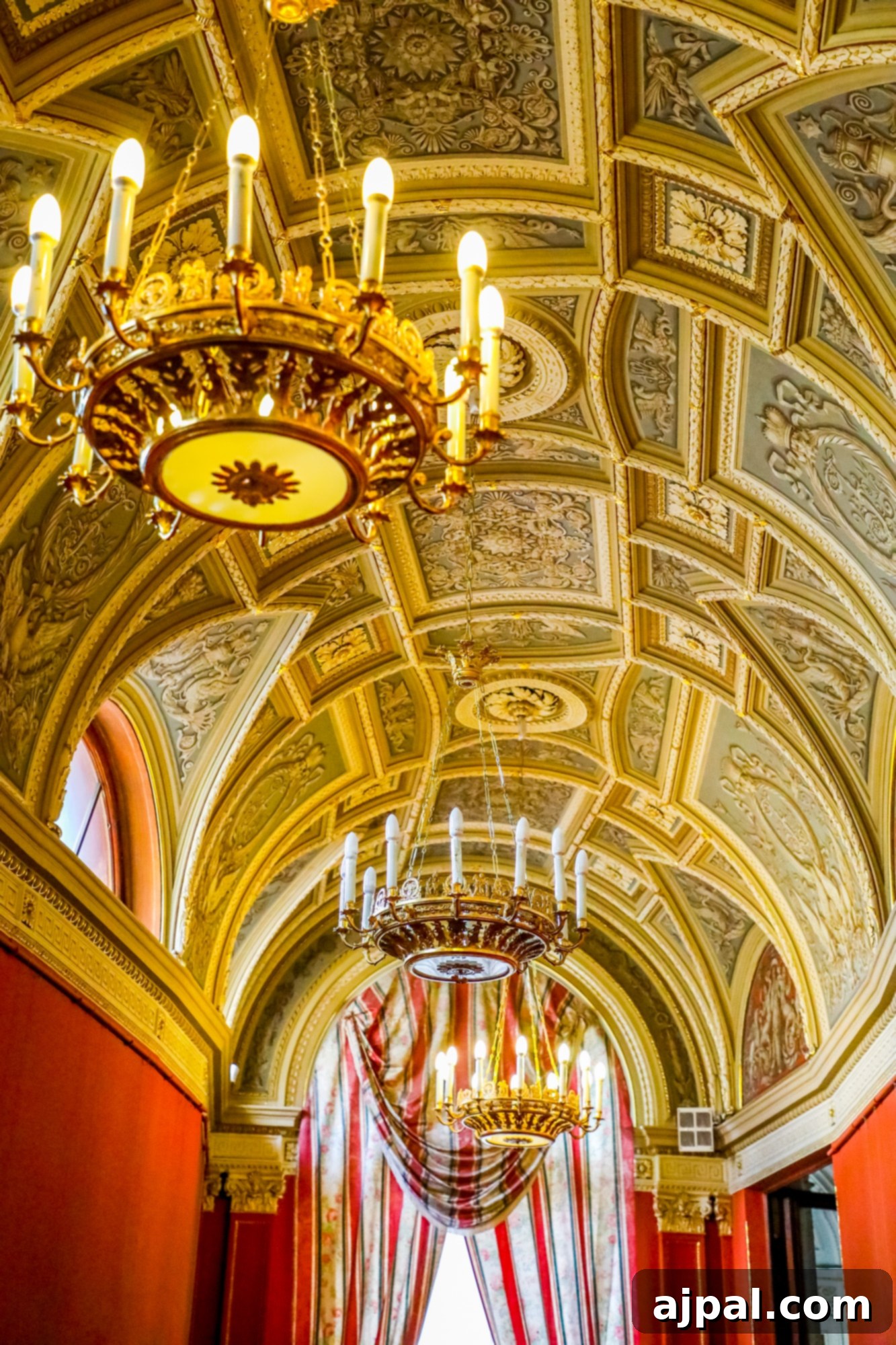 An ornate ceiling in a room with a magnificent chandelier, a luxurious detail in Saint Petersburg, Russia, possibly Yusupov Palace.
