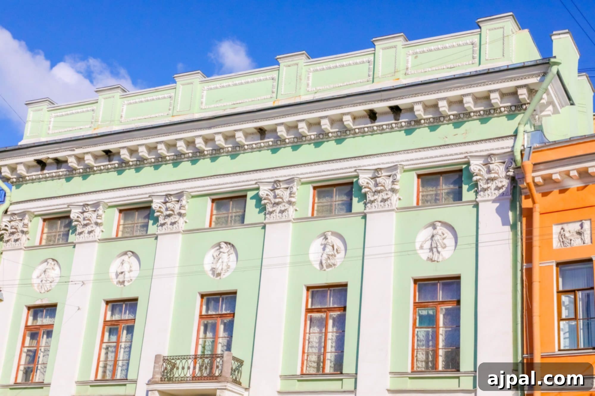 A vibrant, colorful building on a street, typical of Saint Petersburg's charming architecture, ideal for a Princess Cruises shore excursion.