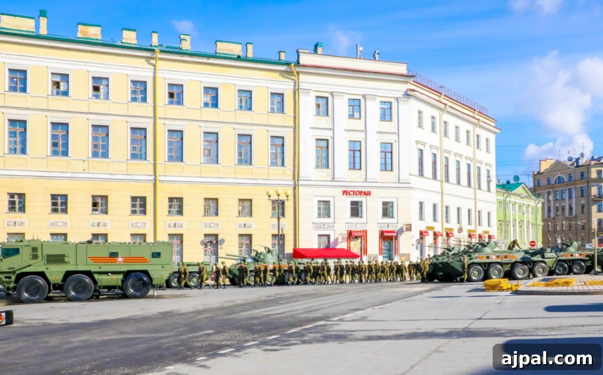 Military vehicles parked in front of a historic building, part of a Saint Petersburg Shore Excursion, showcasing Russian military might.
