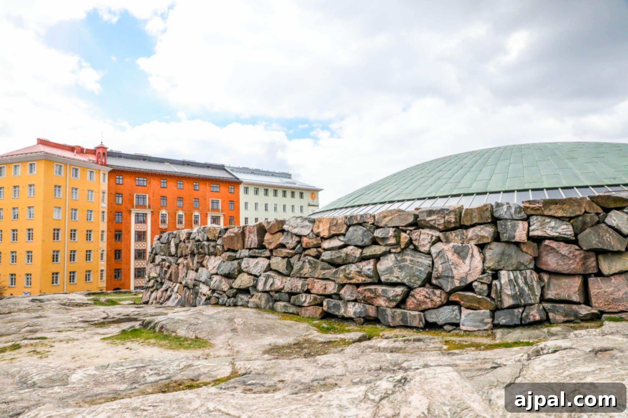 The impressive facade of Temppeliaukio Church in Helsinki, seamlessly integrated with natural rock formations.