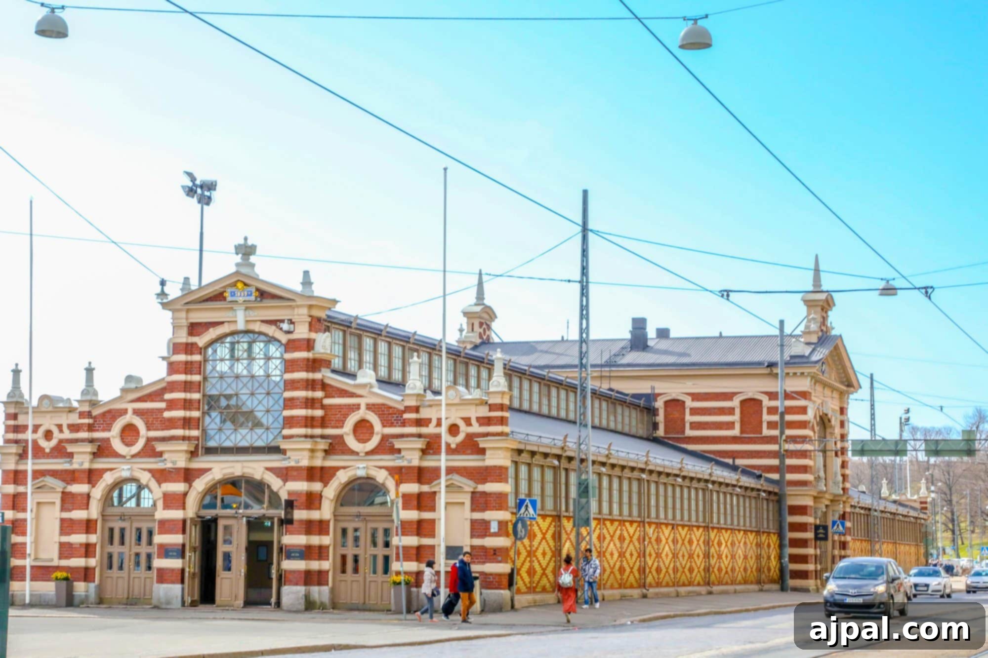 The elegant red brick exterior of Helsinki's Old Market Hall, a historical landmark by the harbor.