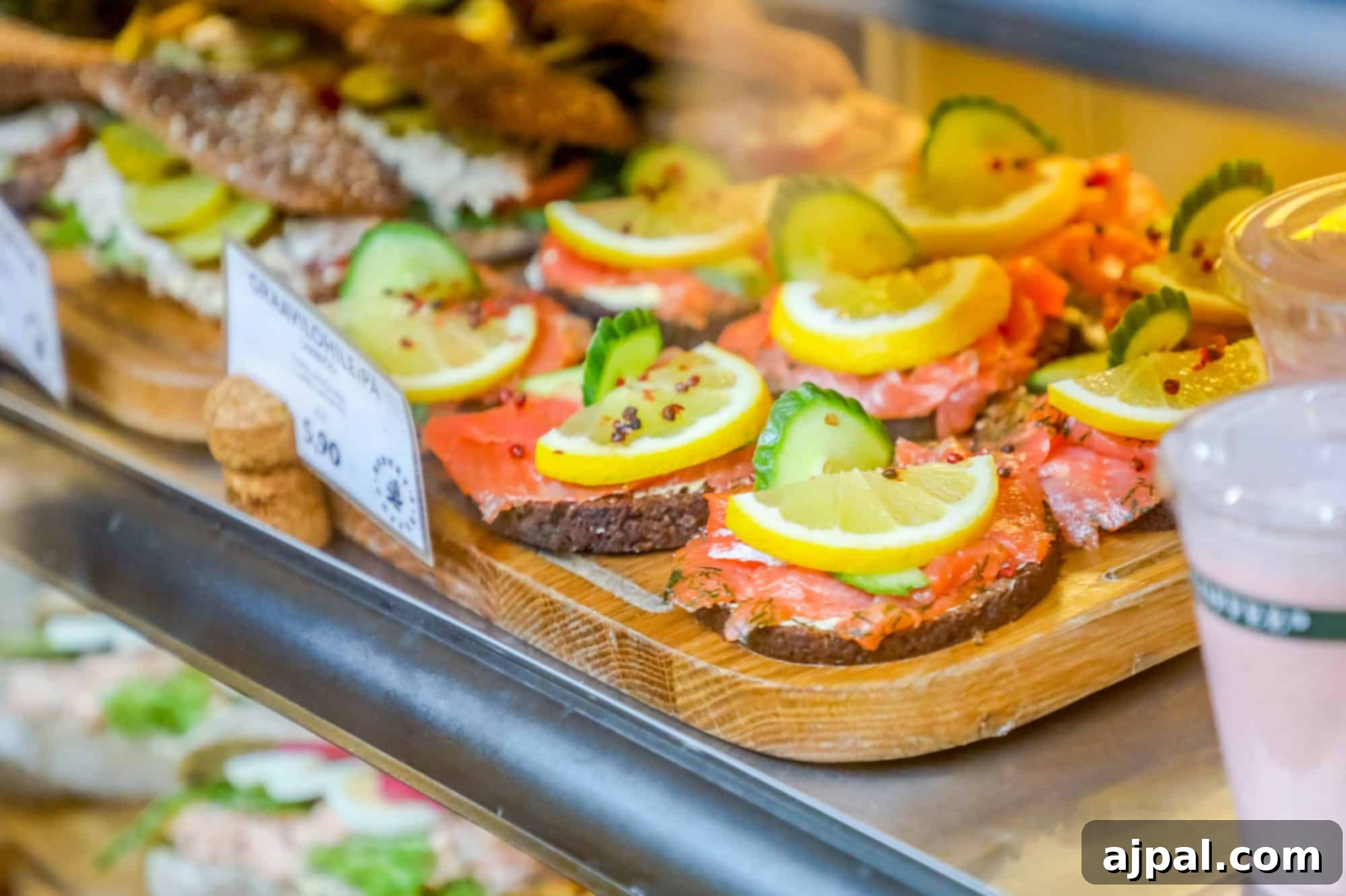 A delicious display of salmon sandwiches and drinks showcased in a glass case, a popular offering in Helsinki.