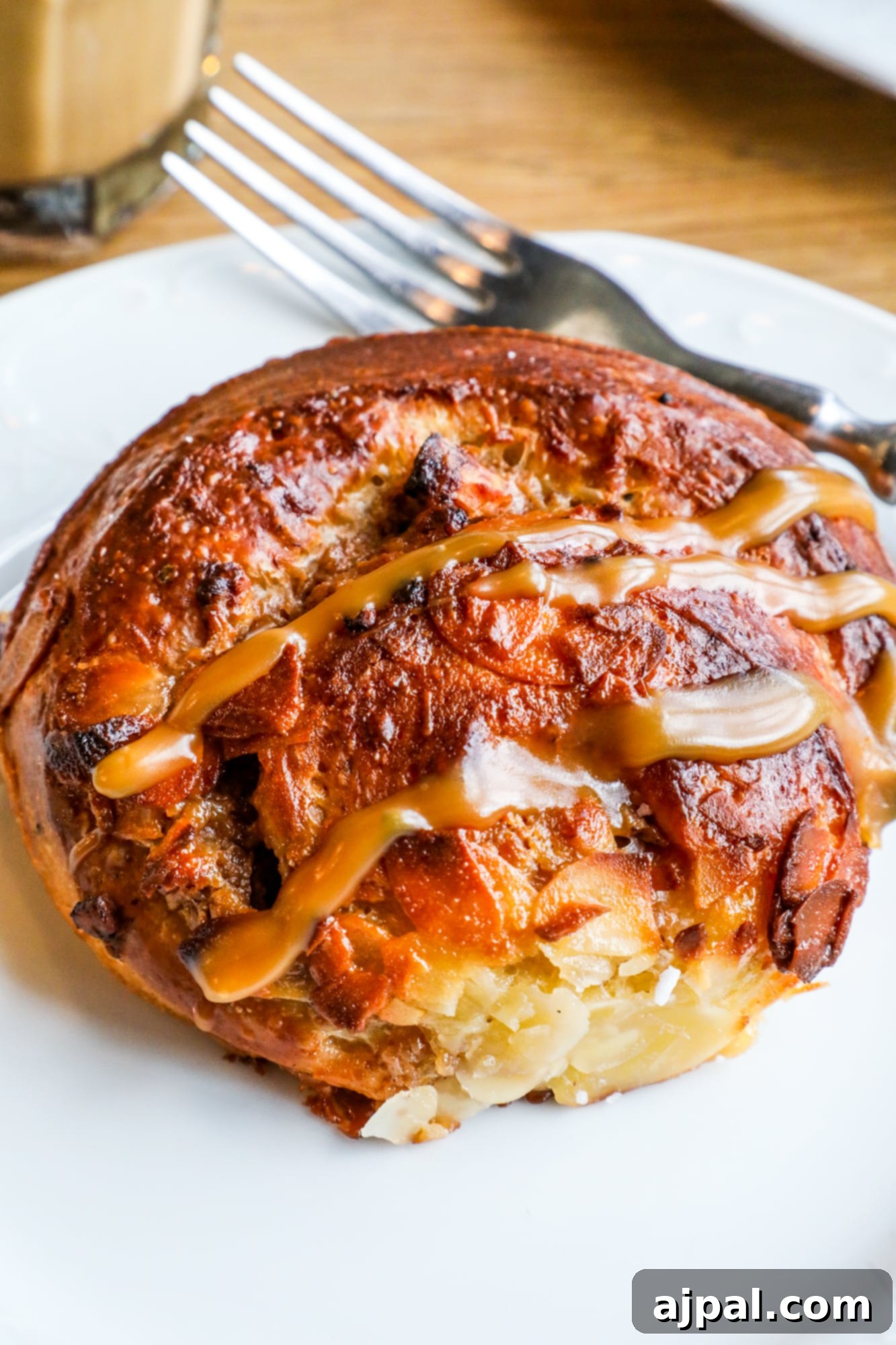 A delectable cinnamon roll paired with a rich latte, a perfect treat from Story Cafe in Helsinki.