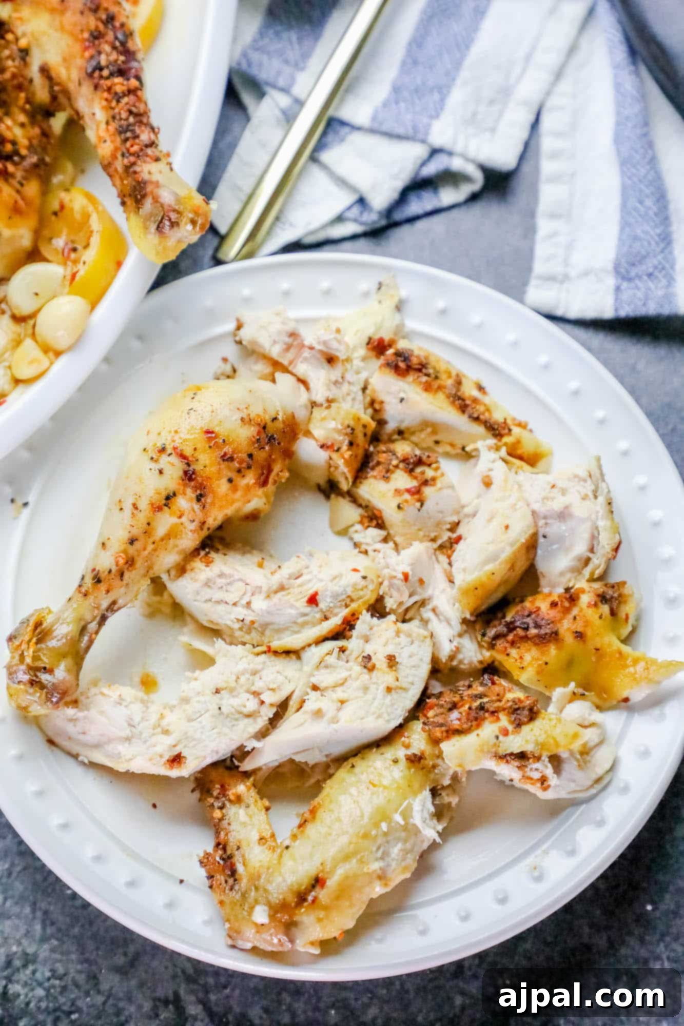 Effortless Whole Montreal Roast Chicken 2 A beautifully roasted Montreal chicken, seasoned with aromatic spices, on a elegant serving platter, ready to be carved and enjoyed.