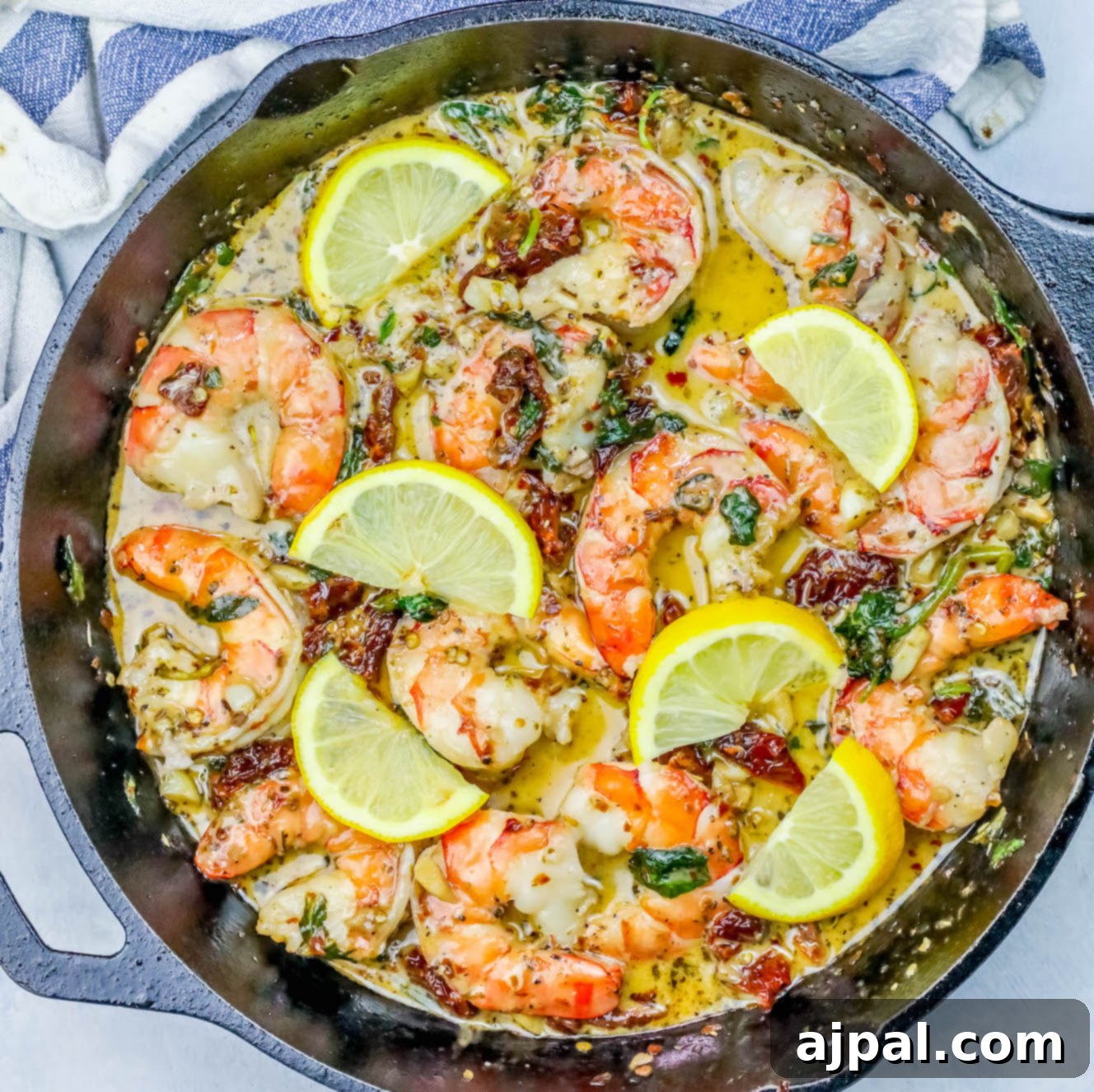 One Pot Creamy Shrimp Florentine Skillet filled with perfectly cooked shrimp and vibrant lemon slices.