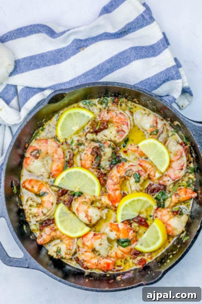 Creamy shrimp skillet featuring plump shrimp and bright lemon slices, ready to be devoured.