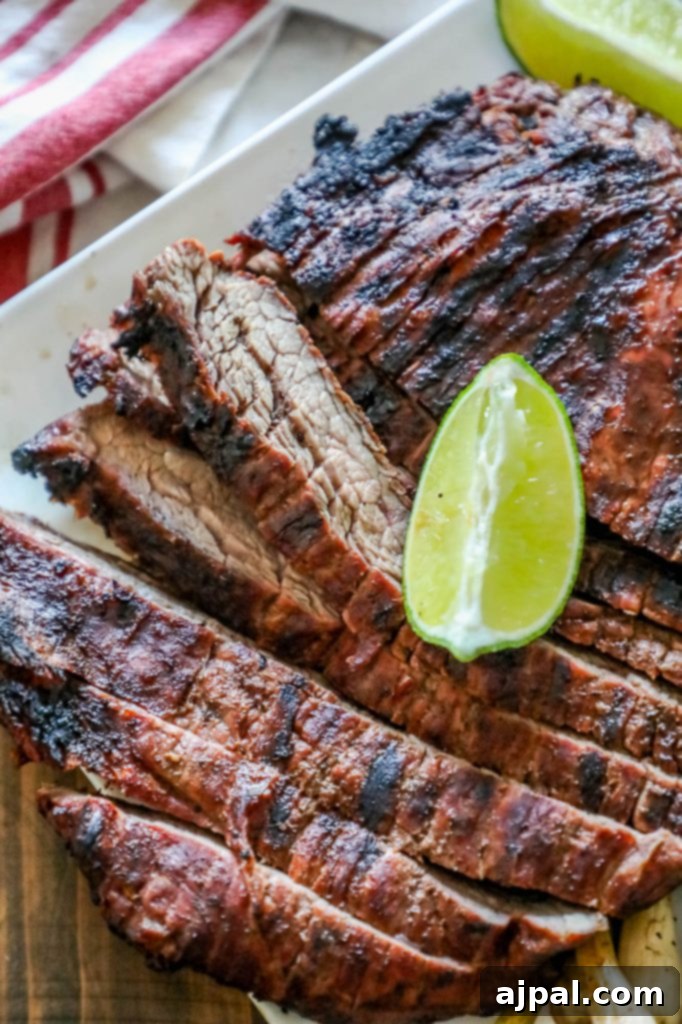 A vibrant platter of perfectly grilled steak, garnished with fresh lime wedges, showcasing a delicious and simple meal idea for any occasion.