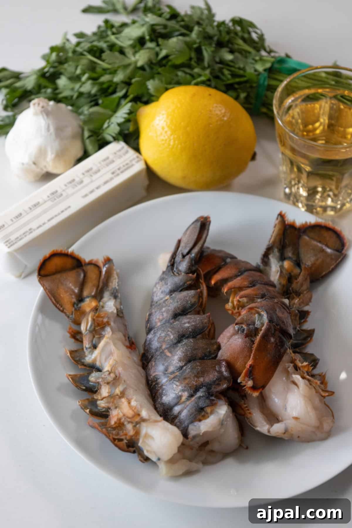 Decadent Butter Poached Lobster Tails 3 Fresh lobster tails, split lengthwise and seasoned, ready for poaching.