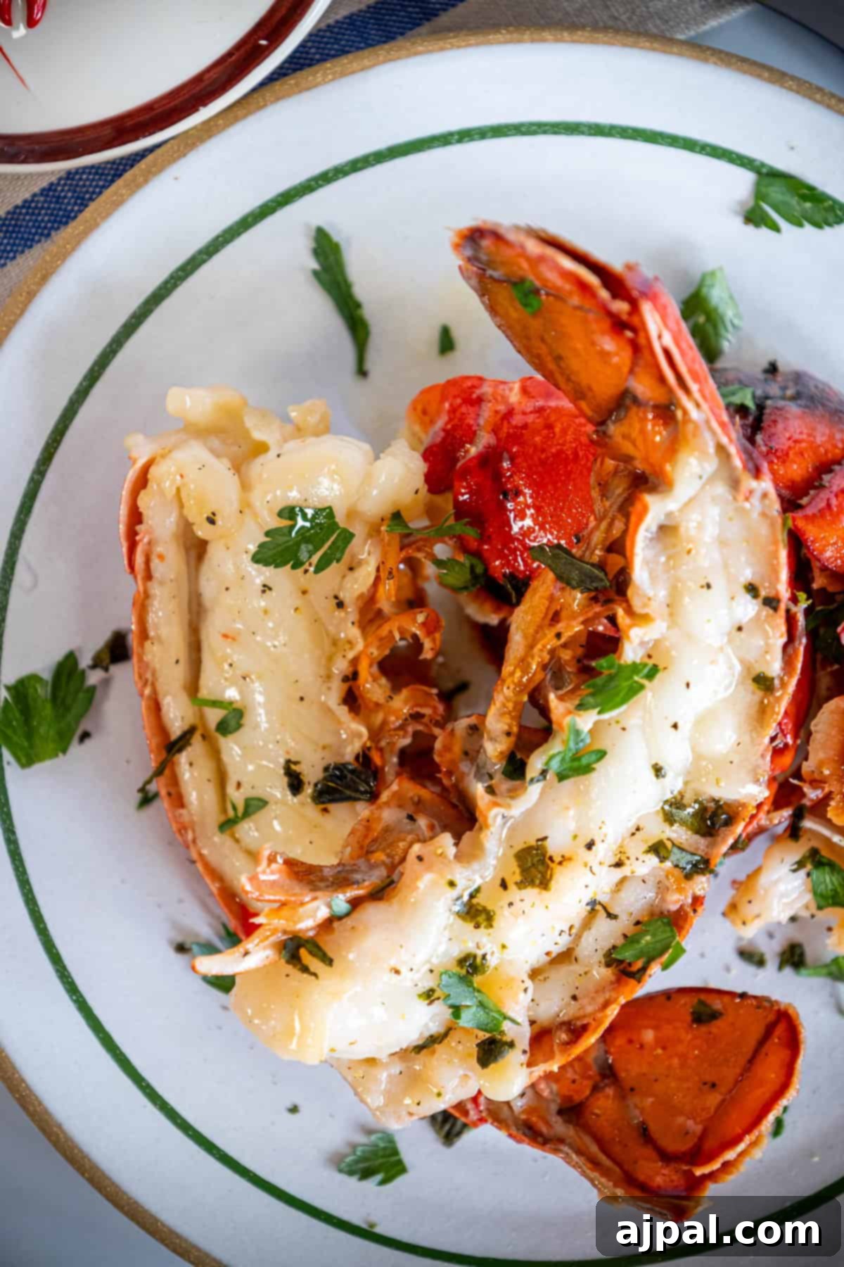 Decadent Butter Poached Lobster Tails 5 Perfectly cooked butter-poached lobster tail, opaque and slightly curled, ready to be served.