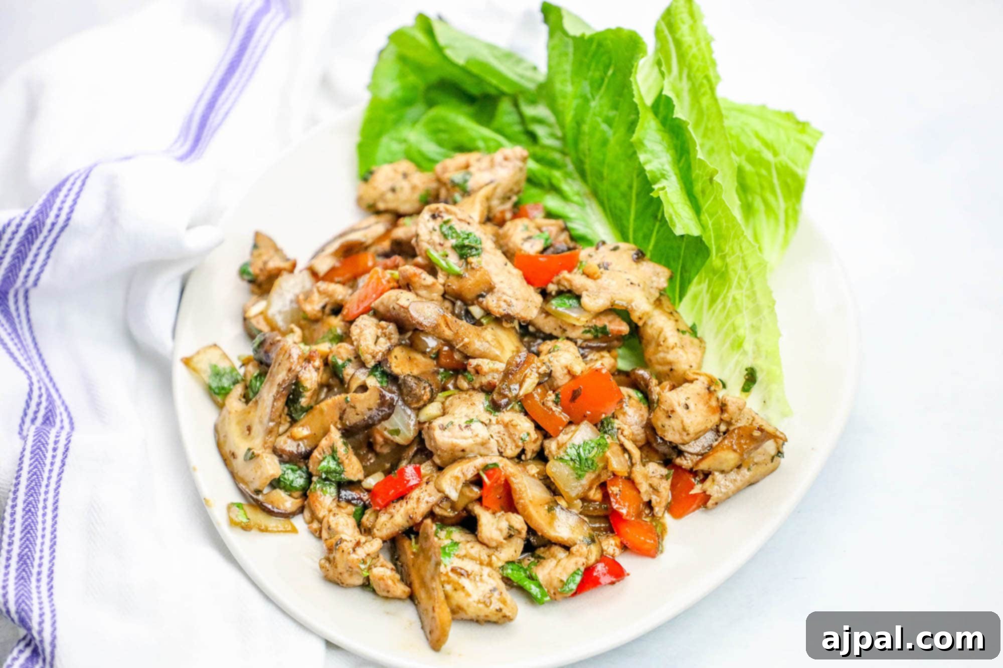 Close-up of low-carb ranch seasoned pork filling served on a white plate with fresh lettuce cups.