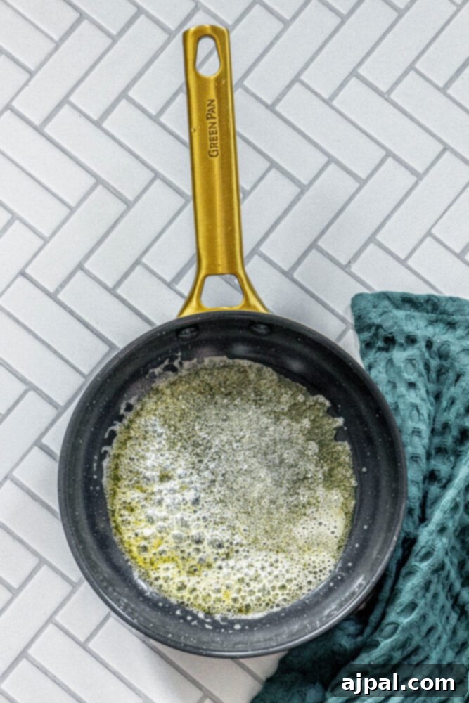 Greek Pan Fried Halloumi Recipe 5 Melted butter shimmering in a nonstick pan, ready for cooking halloumi cheese.