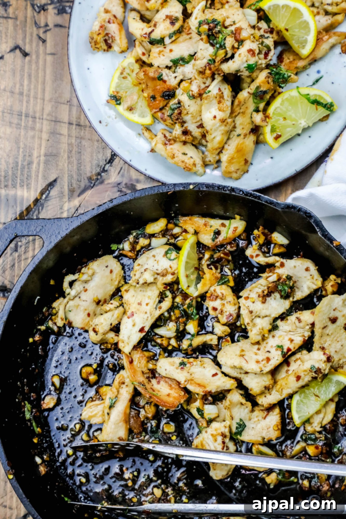 Spicy Lemon and Garlic Pan-Fried Chicken Strips served fresh from the skillet with vibrant lemon wedges.