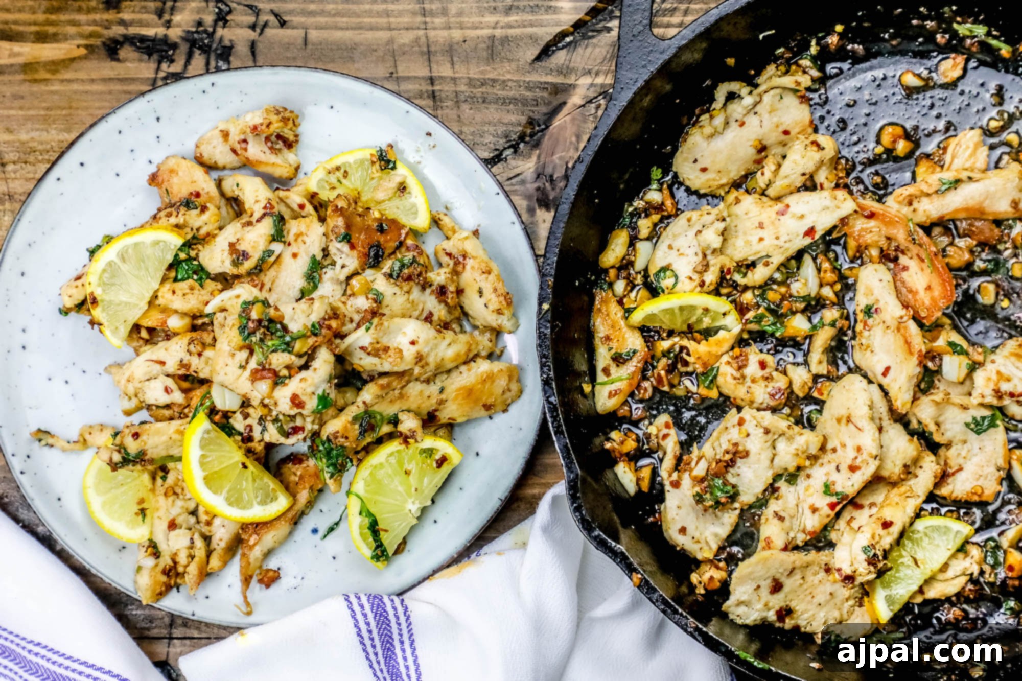 Low-carb pan-fried chicken strips seasoned with spicy lemon and garlic, served on a plate with fresh herbs.