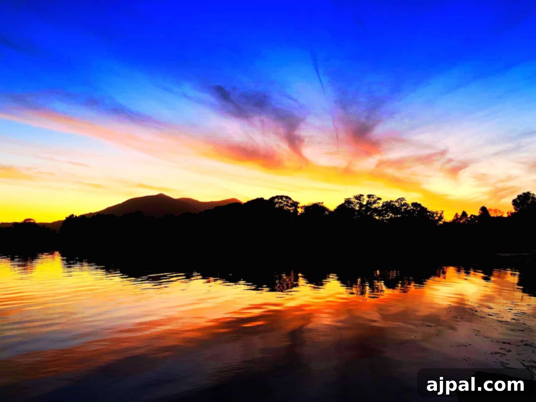 Uncovering Killarney Ireland's Gems 4 A picturesque sunset over a lake with majestic mountains in the background, capturing the essence of Killarney, Ireland.