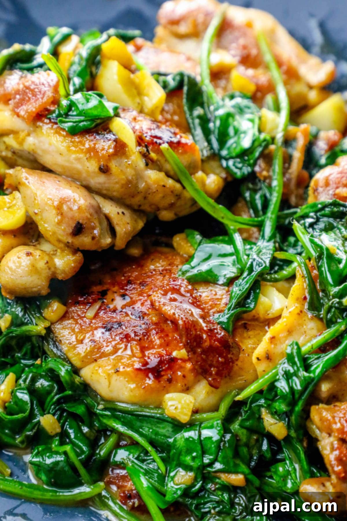 Easy Skillet Bacon Garlic Chicken and Spinach 3 One-pot skillet with browned chicken, crispy bacon bits, and wilted spinach, ready to serve.