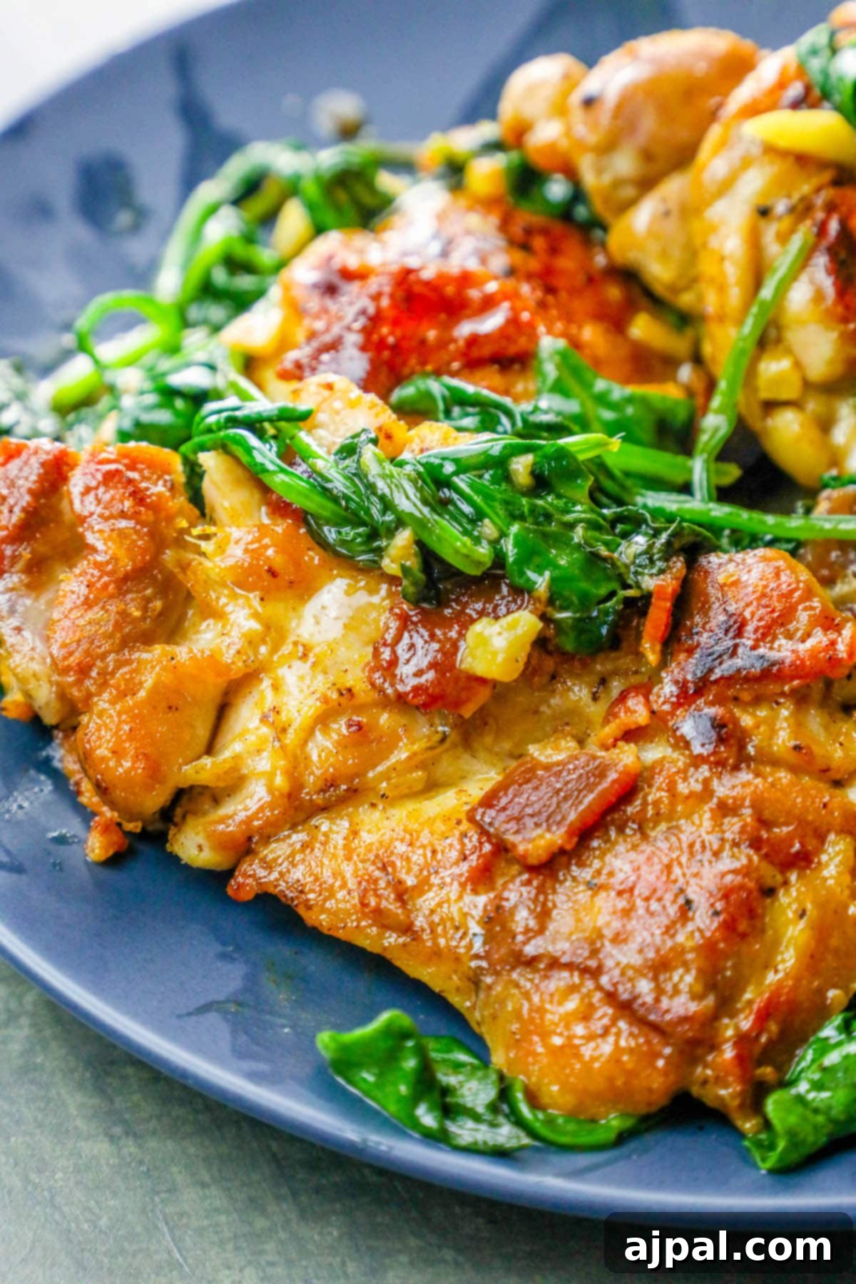 Easy Skillet Bacon Garlic Chicken and Spinach 5 Ingredients for one-pot bacon garlic chicken and spinach laid out beside a skillet.