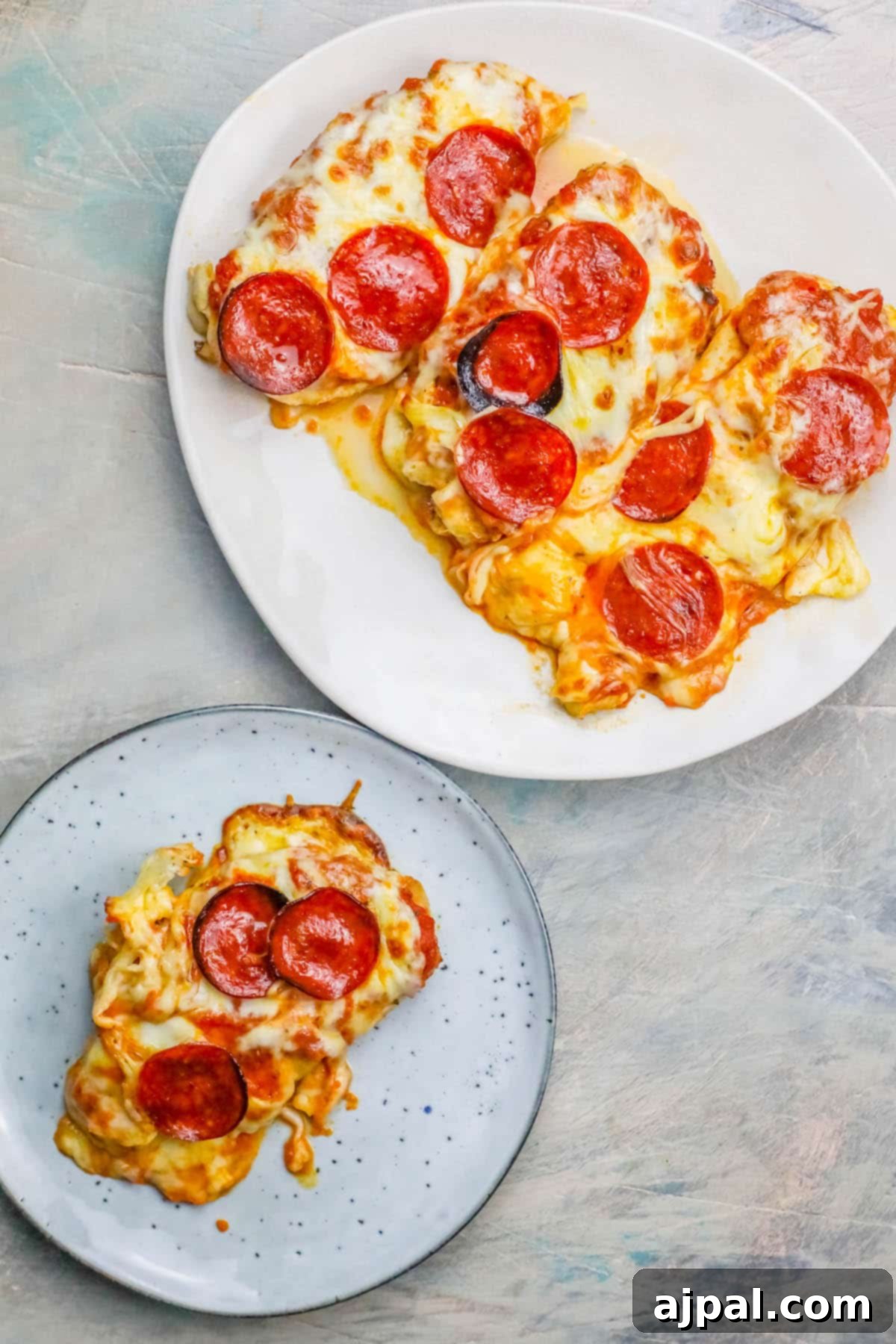 Easy Cheesy Keto Low Carb Chicken Pizza 2 Close-up of golden-brown Low Carb Keto Cheesy Pizza Chicken with bubbly cheese and pepperoni on a white plate, ready to serve.