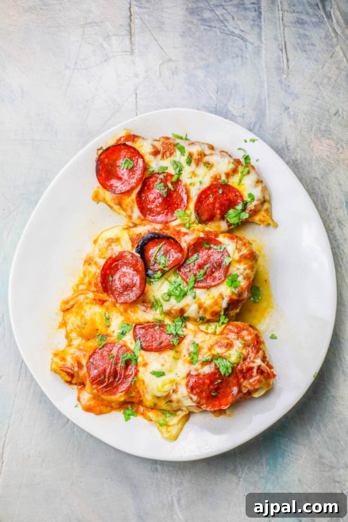 Easy Cheesy Keto Low Carb Chicken Pizza 5 A vibrant close-up of a Low Carb Cheesy Chicken Pizza, featuring a perfectly baked chicken base, generously topped with melted mozzarella and crisp pepperoni slices.