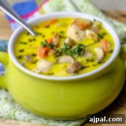 Chicken mushroom soup in a green bowl with a spoon that is keto-friendly.