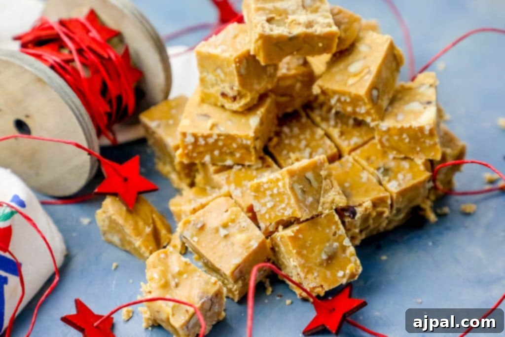 Ultimate Slow Cooker Walnut Butterscotch Fudge 2 A festive pile of golden-brown Walnut Butterscotch Slow Cooker Fudge pieces on a blue table, ready for holiday enjoyment.