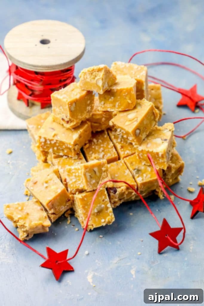 Luscious Butterscotch Walnut Slow Cooker Fudge 5 Close-up of beautifully cut Walnut Butterscotch Slow Cooker Fudge squares arranged on a festive blue background with playful red stars.