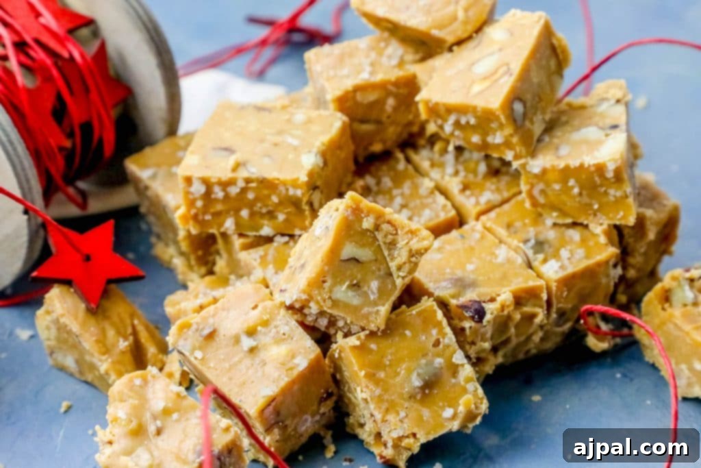 Ultimate Slow Cooker Walnut Butterscotch Fudge 6 A tempting display of Walnut Butterscotch Slow Cooker Fudge pieces, highlighting their golden hue and inviting texture, set against a blue backdrop.