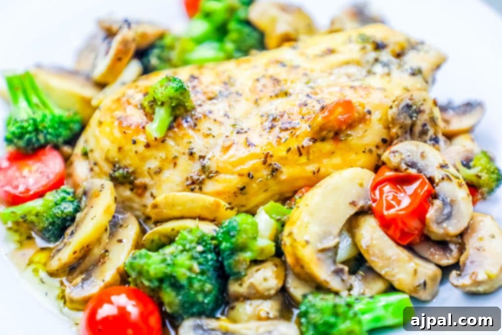 One-Pot Italian Chicken and Veggie Skillet 2 Juicy Italian chicken breast served with a vibrant medley of broccoli, tomatoes, and mushrooms, drizzled with savory sauce on a white plate.
