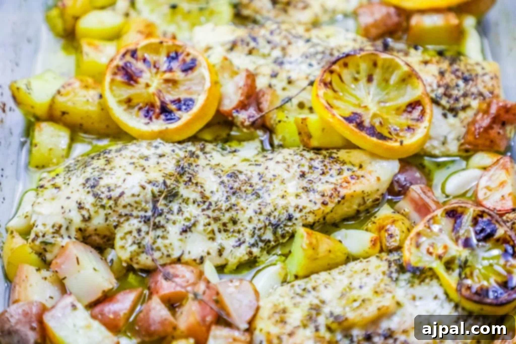 A Greek-inspired baking sheet meal with chicken, potatoes, and lemons, fresh out of the oven.