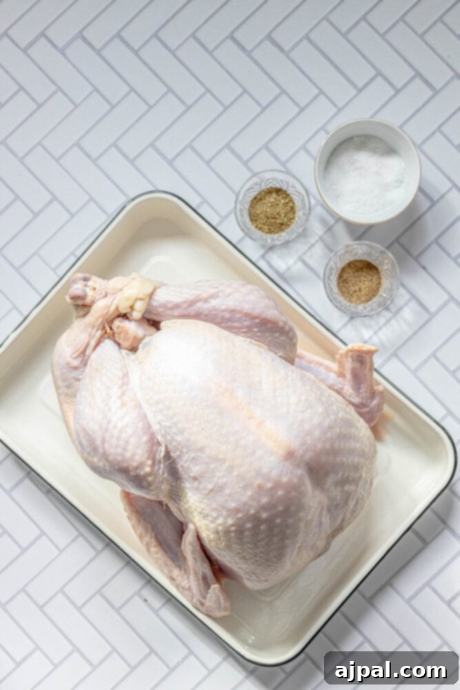 Flavorful Herb Roasted Turkey in a Bag 5 picture of turkey on a tray next to salt, pepper, and herbs