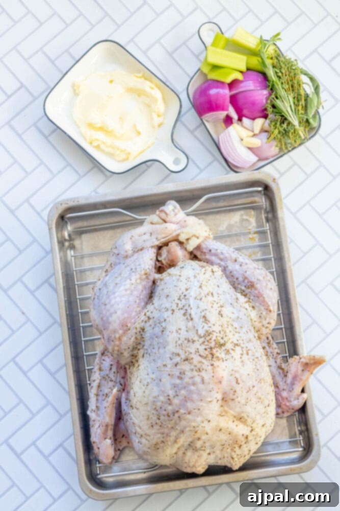 Flavorful Herb Roasted Turkey in a Bag 7 picture of brined turkey next to butter, herbs, chopped onion, softened butter on a table