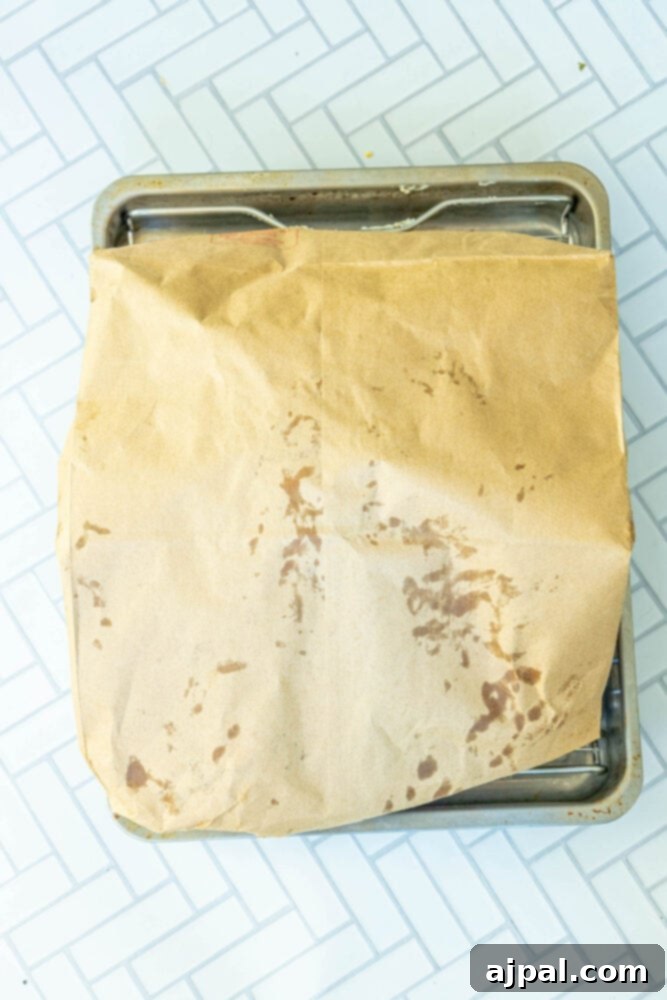 Flavorful Herb Roasted Turkey in a Bag 9 picture of a brown paper bag on a roasting pan