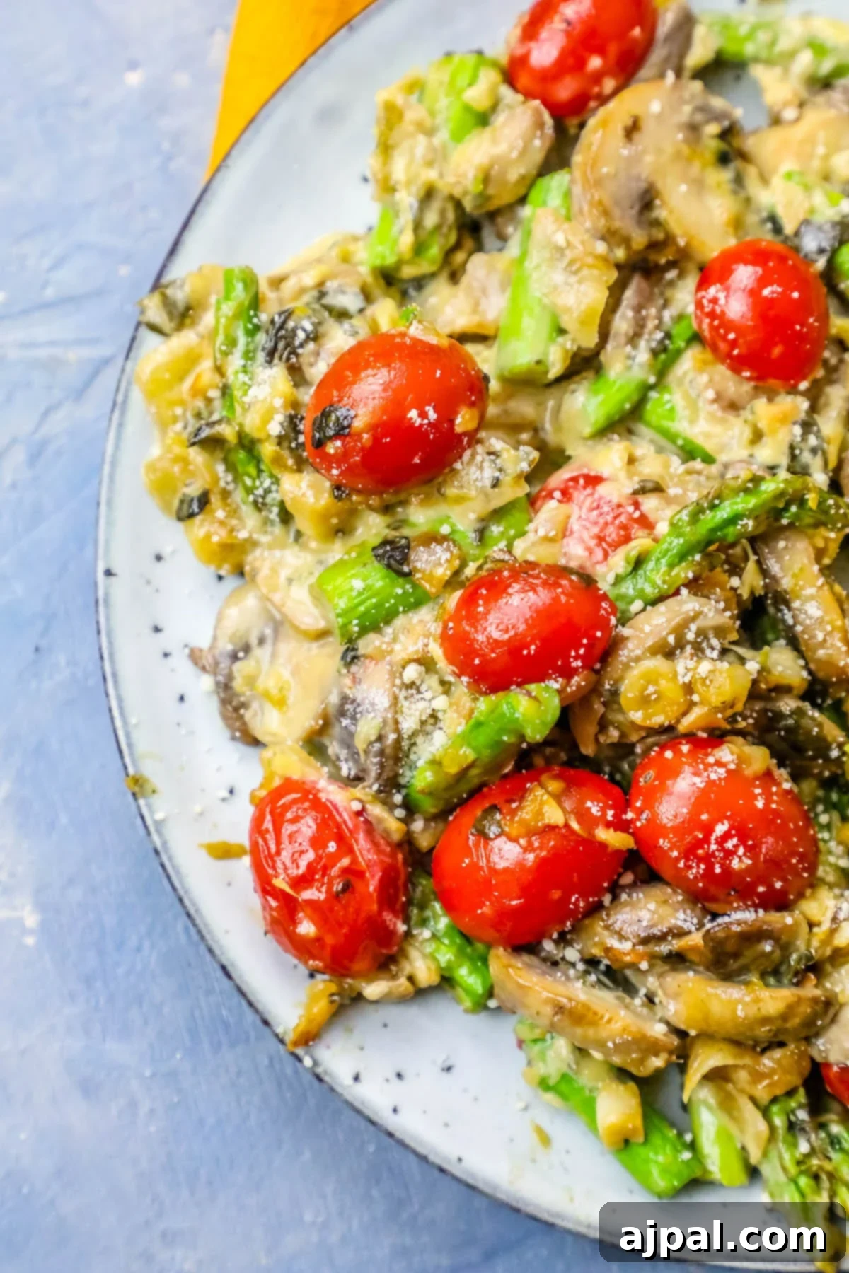 A creamy skillet vegetable side dish recipe with mushrooms and asparagus.