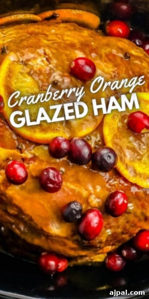 Slow Cooker Ham with Zesty Orange Cranberry Ginger Glaze 9 Easy Christmas ham recipe with cranberry orange glaze, featuring a cooked ham with fresh garnishes.