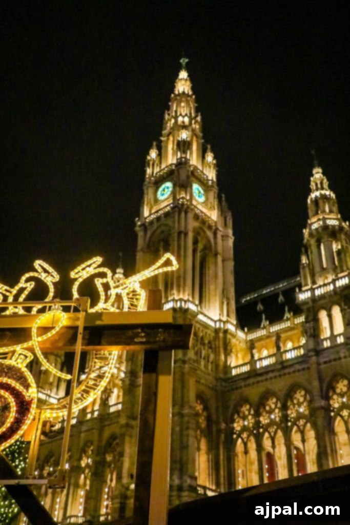 The grand Rathaus (City Hall) in Vienna, adorned with Christmas lights and surrounded by market stalls