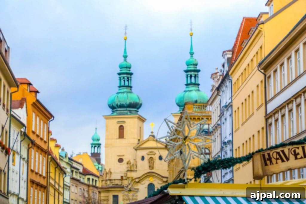 A charming street in Prague's Old Town, adorned with Christmas lights and historical buildings