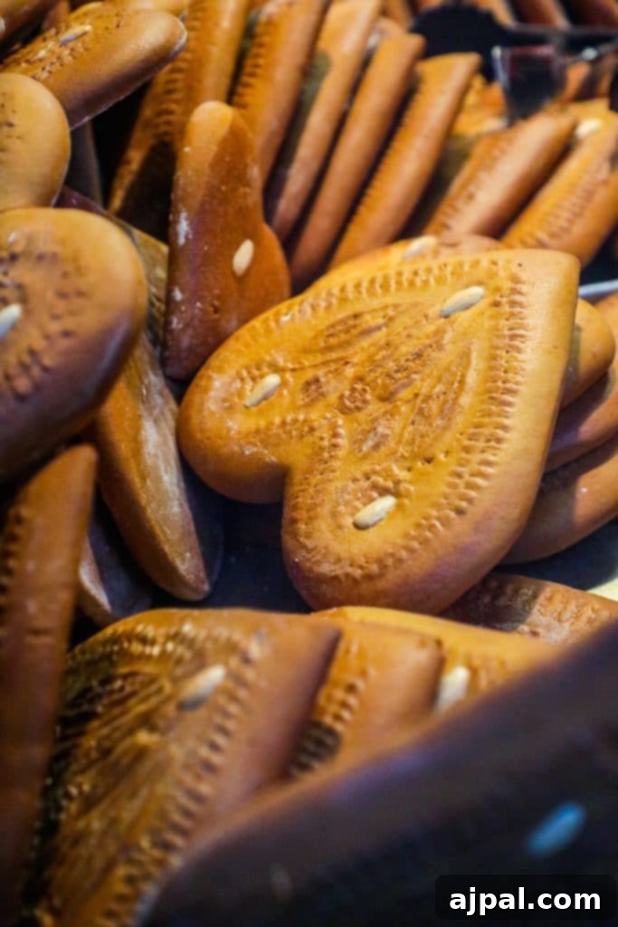 A pile of heart-shaped gingerbread cookies, beautifully decorated for Christmas, at a German market