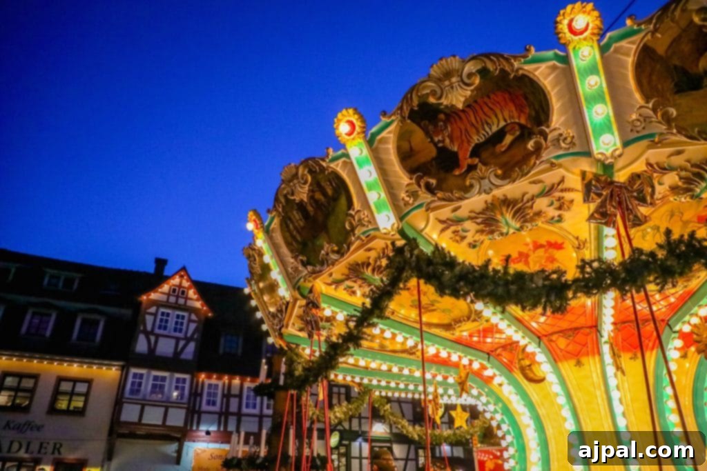 A festive carousel brightly lit at night within a German Christmas market, surrounded by timber-framed buildings
