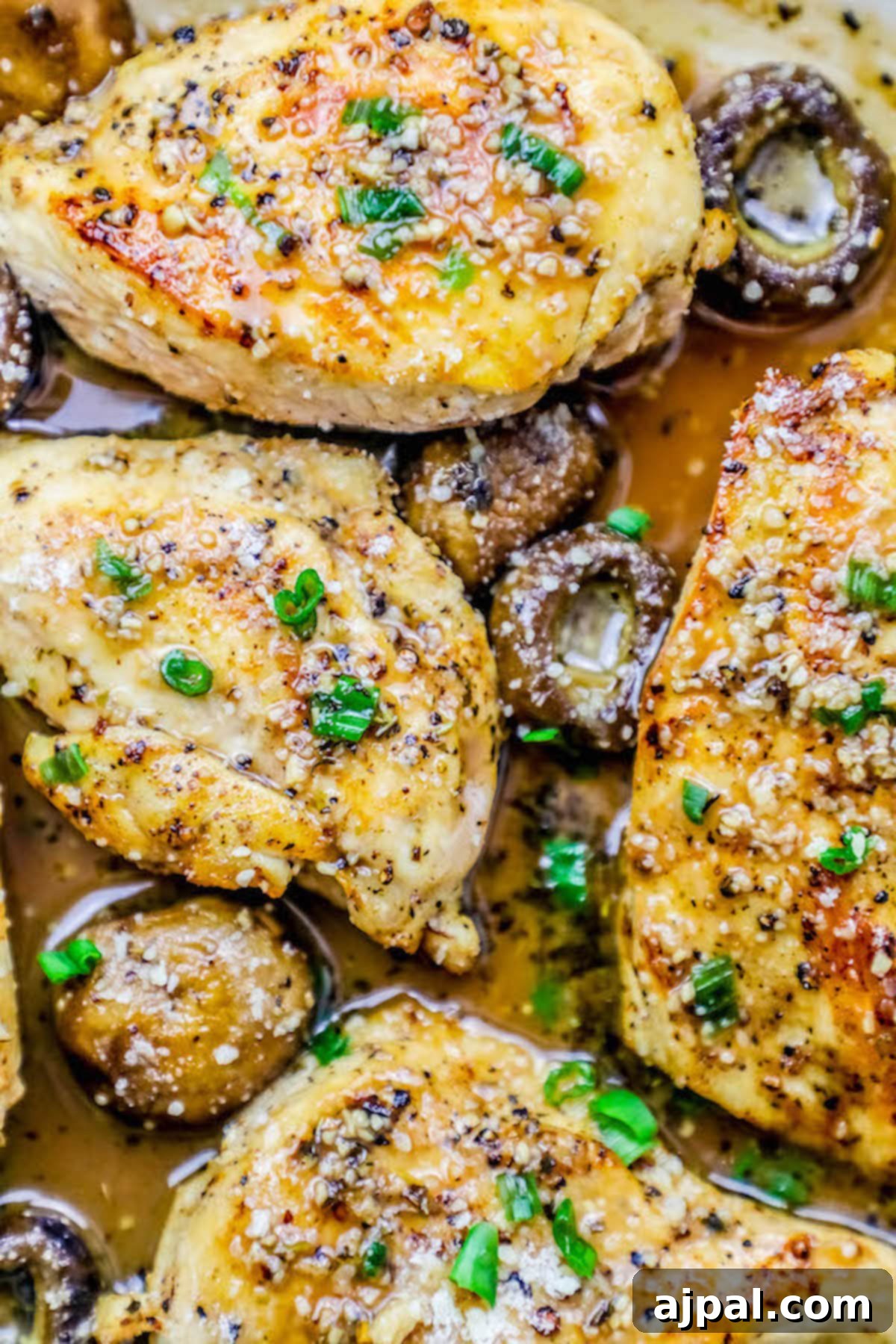 Pan-Seared Garlic Parmesan Chicken and Mushrooms 3 Juicy chicken breasts and savory mushrooms simmering in a rich garlic Parmesan butter sauce, garnished with fresh herbs.