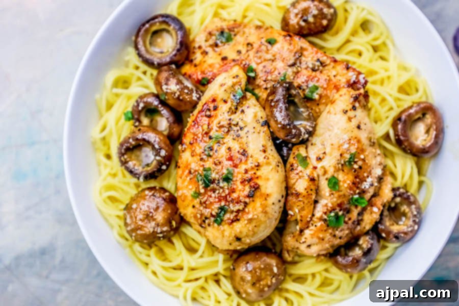 picture of chicken breast on pasta with mushrooms around it and spices