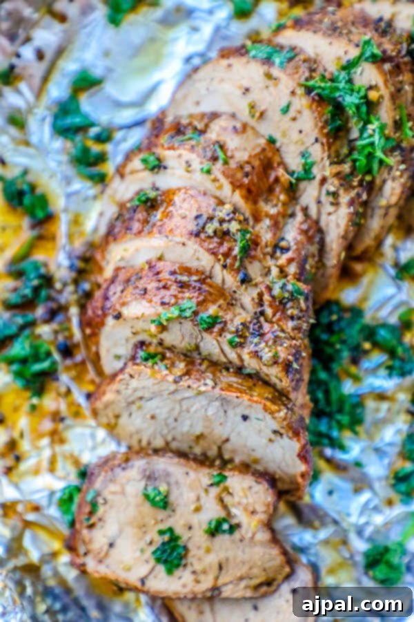 Your New Favorite Baked Pork Tenderloin 12 Easy baked pork tenderloin recipe with herbs on top, wrapped in foil.
