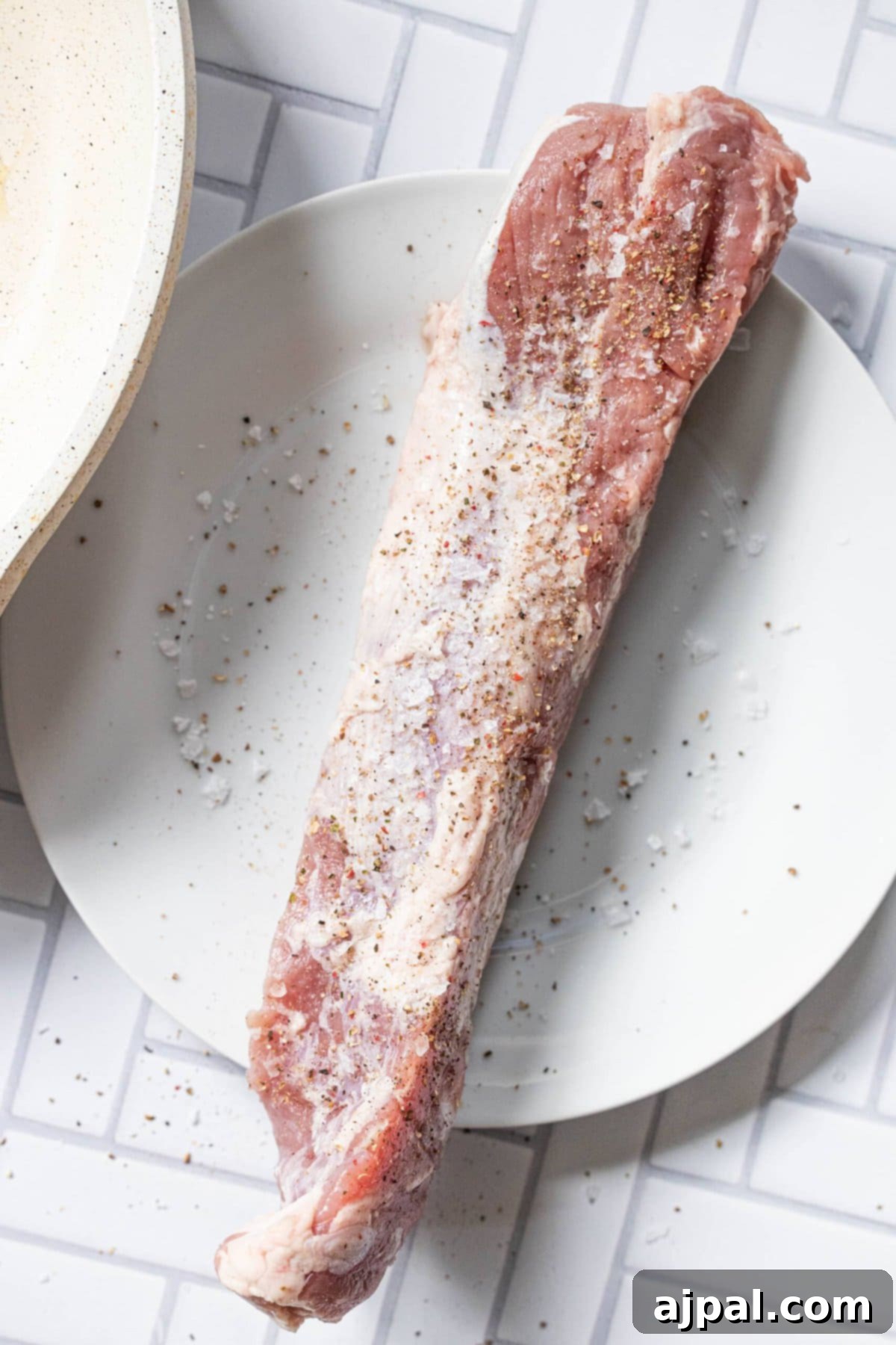 Your New Favorite Baked Pork Tenderloin 5 raw seasoned pork tenderloin