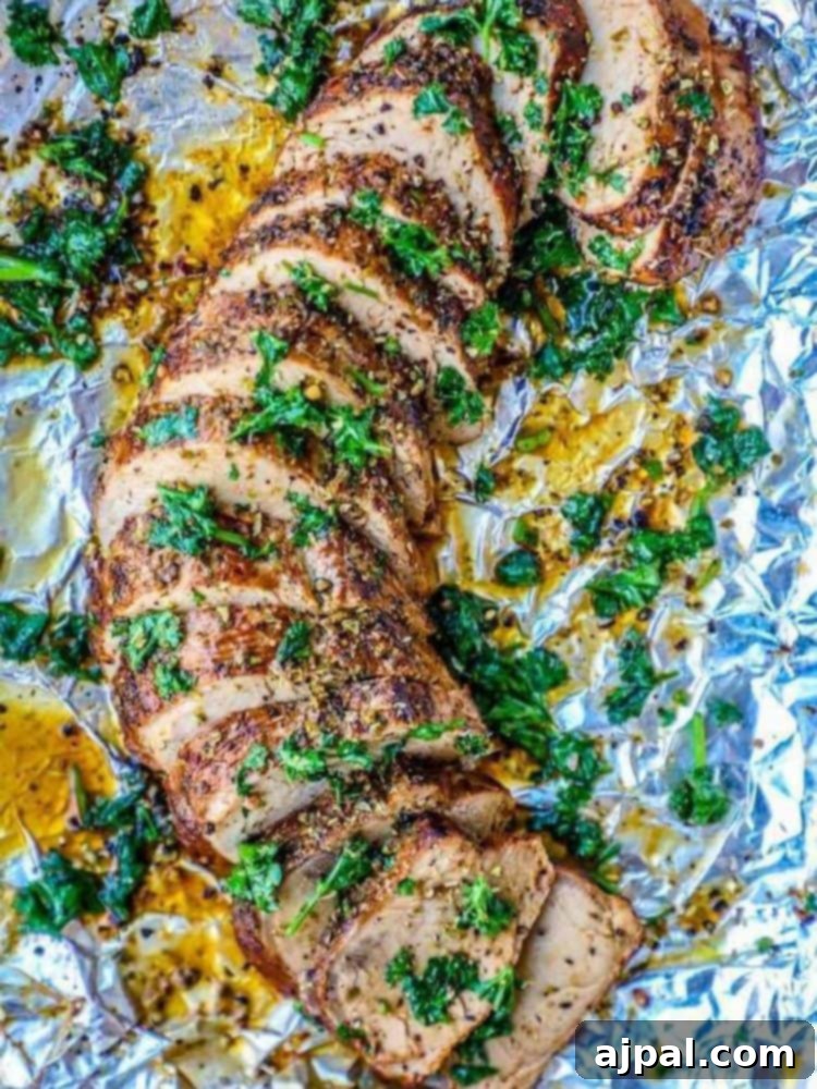 Your New Favorite Baked Pork Tenderloin 11 A deliciously baked pork tenderloin on a foil sheet.
