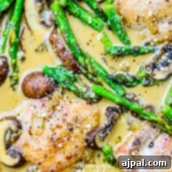 Creamy Italian chicken with mushrooms and asparagus in a white sauce.