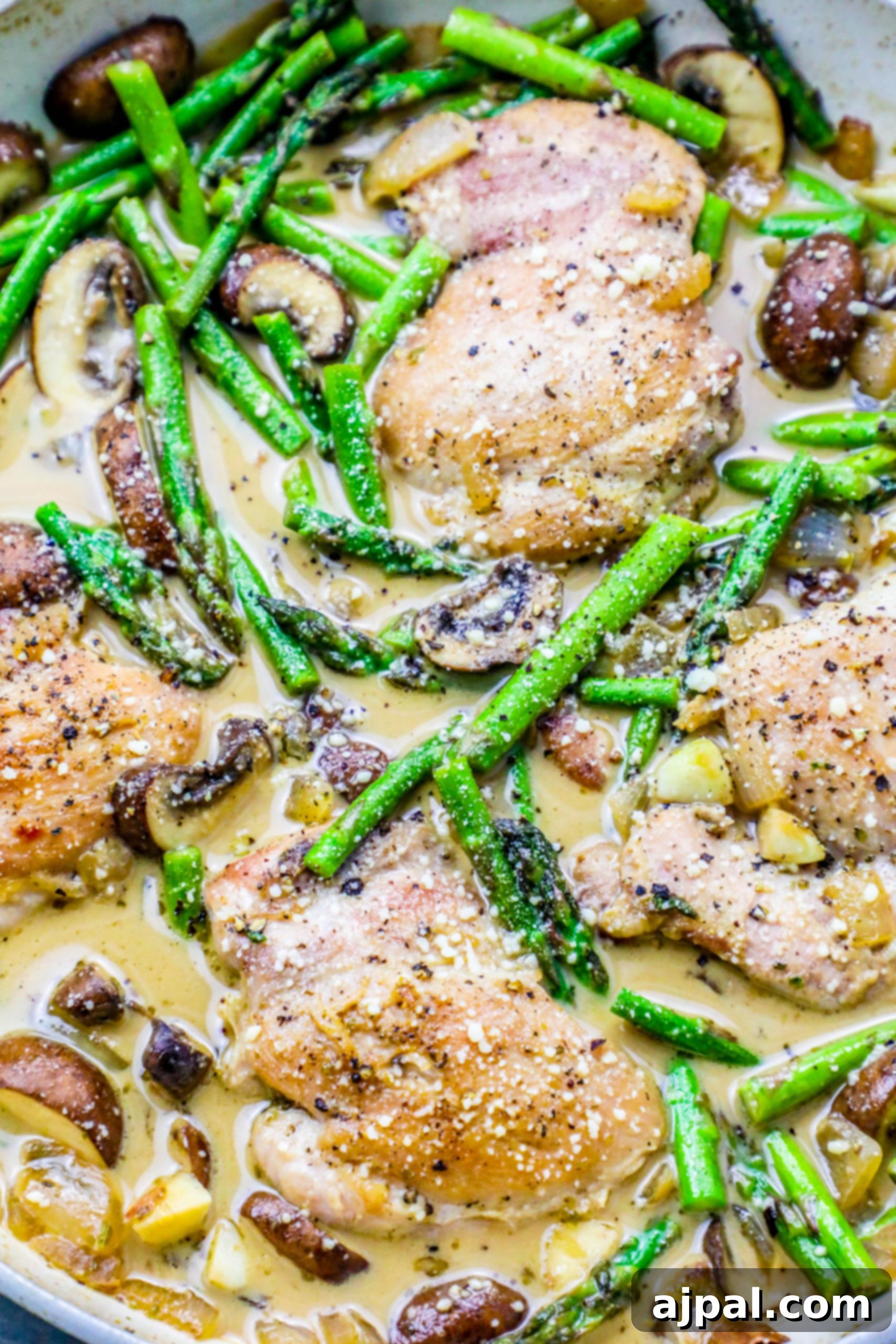 pan with chicken, asparagus, mushrooms, and creamy sauce