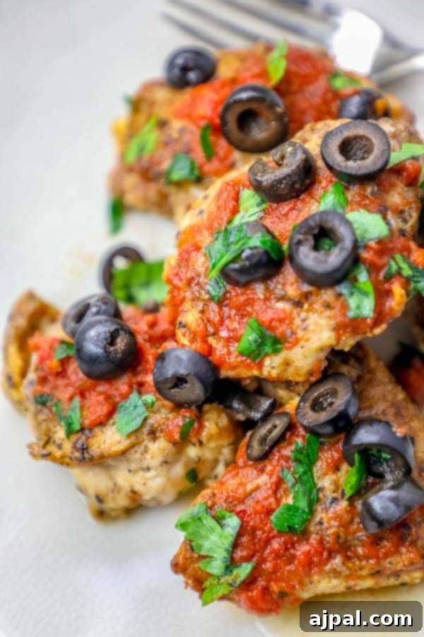 Delicious salsa chicken thighs garnished with cilantro and olives, ready to serve.