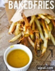 Crunchy baked fries with a side of dipping sauce.