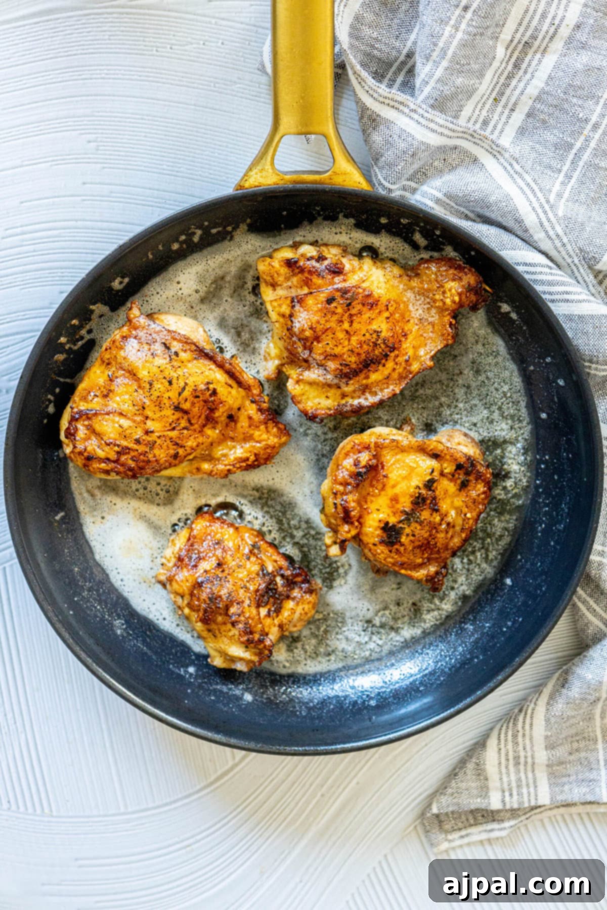 Sizzling Skillet BBQ Chicken Thighs 5 picture of chicken thighs frying in a pan with butter