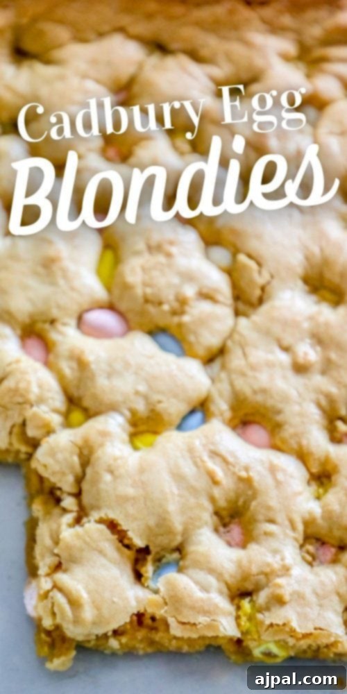 Easy Cadbury Mini Egg Blondies baking on a sheet, showcasing their golden crust and visible candy pieces.