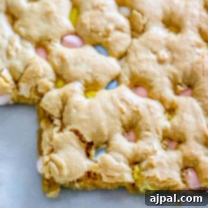 Easter Candy Recipes: Easy Blondies Recipe featuring Cadbury Mini Eggs, baked on a sheet.