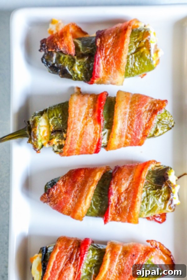 picture of bacon wrapped jalapeno poppers on a plate